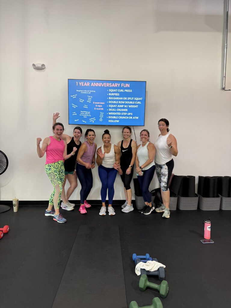 Andrea Gaines Sharp smiling with her team after a strength training workout.