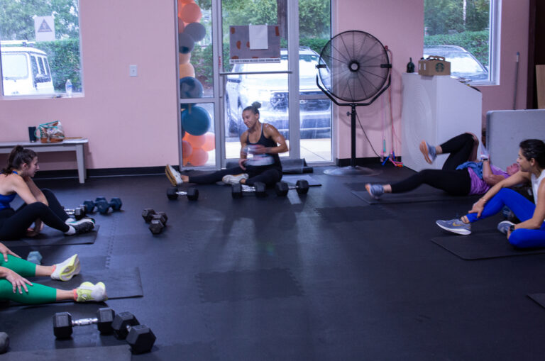 Group fitness class resting on the floor after a hard workout at Good Gaines Fitness in Cornelius, NC