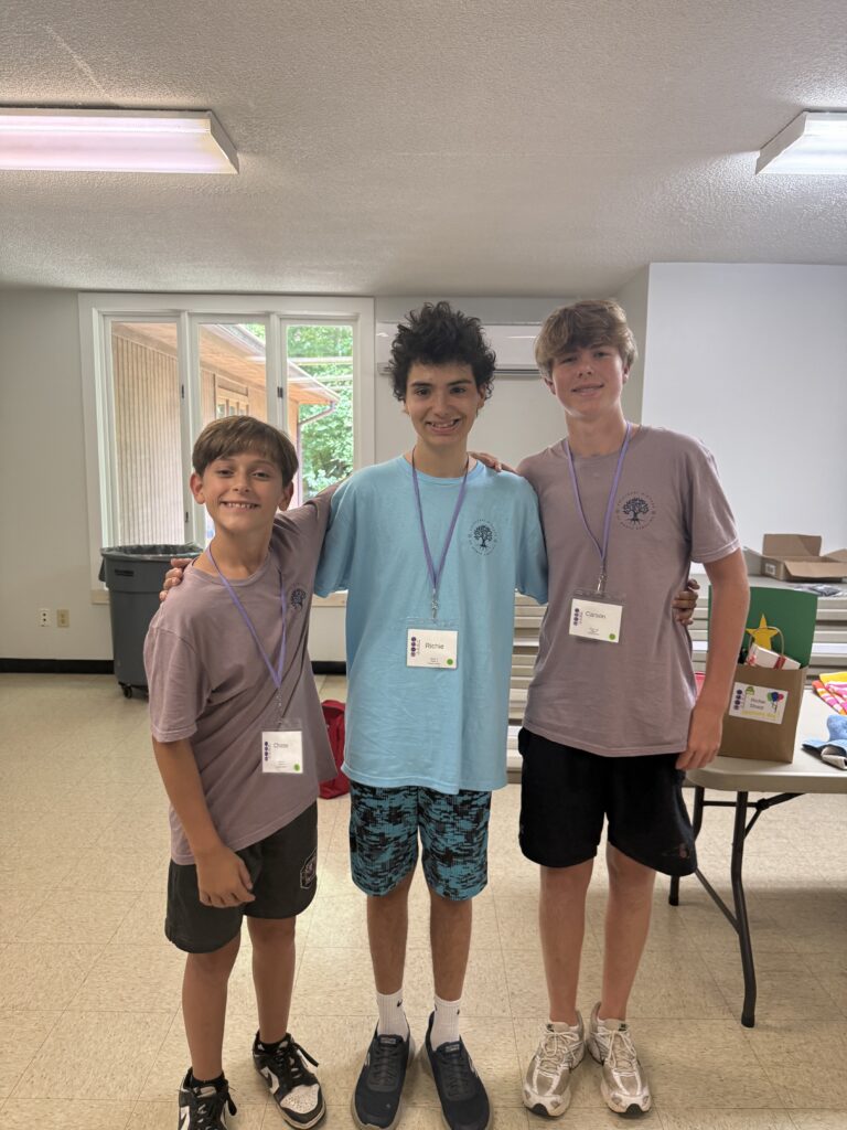 Richie surrounded by friends at HUGS camp an inclusive summer camp in North Carolina
